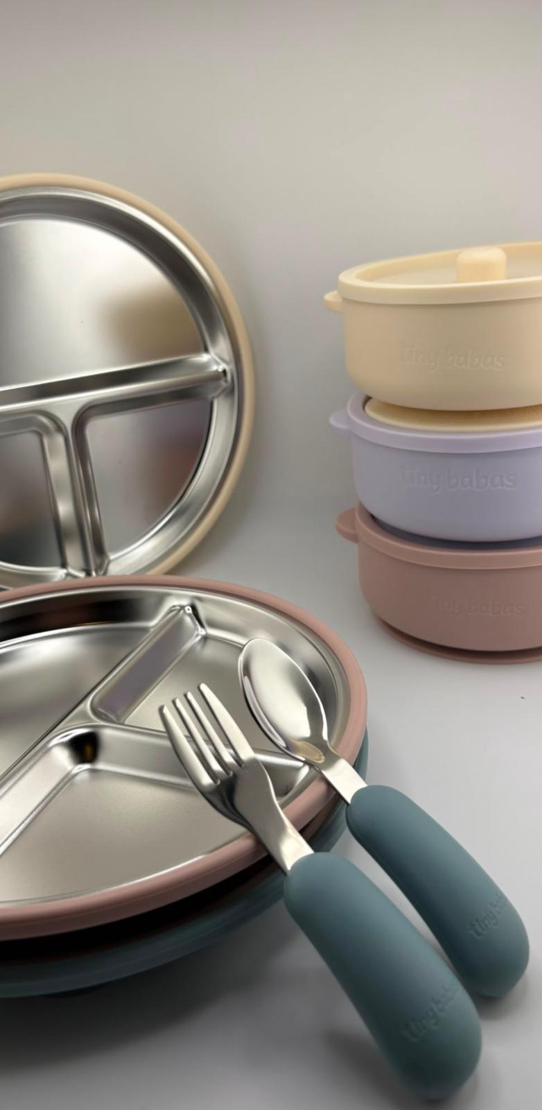 Baby weaning set in blue (2 in 1 stainless steel and silicone bowl with lid, silicone bib, stainless steel cutlery with silicone handle) Light Taupe silicone baby feeder with tray and hygienic lid. 